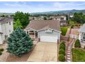 Aerial view of house showcasing landscaping, neighborhood, and mountain views at 9620 Mallard Pond Way, Littleton, CO 80125