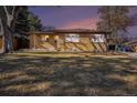 Charming brick home with large front yard and mature trees in a quiet neighborhood at 1623 S Ivy Way, Denver, CO 80224