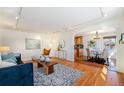 Bright living room featuring hardwood floors, modern lighting, and an open concept layout at 1623 S Ivy Way, Denver, CO 80224
