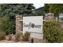 Sunflower community sign with stone pillars and well-maintained landscaping at 3414 S Eagle St # 201, Aurora, CO 80014