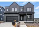 Contemporary two-story home with a covered porch, black trim, and modern architectural details at 924 Sunflower St, Louisville, CO 80027