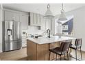 Stylish kitchen featuring an island with seating, stainless steel appliances, and modern finishes at 924 Sunflower St, Louisville, CO 80027