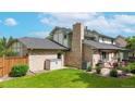 Beautiful brick home featuring a private backyard with a lush lawn and a patio area at 5723 S Kittredge St, Centennial, CO 80015