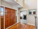 A foyer with hardwood floors, paneled doors, and a study or office room at 2154 S Parfet Dr, Lakewood, CO 80227
