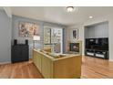 Cozy living room with a fireplace, hardwood floors, and sliding glass doors to the balcony at 3680 S Beeler St # 5, Denver, CO 80237