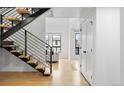 Modern staircase featuring hardwood steps and a sleek railing, leading to upper levels at 6668 Walker Ct, Niwot, CO 80503