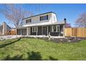 Charming two-story home with a well-maintained front lawn and attached garage at 6087 W 84Th Ave, Arvada, CO 80003
