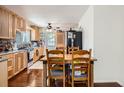 Cozy kitchen featuring wood cabinets, modern appliances, and tile backsplash at 6736 Grove St, Denver, CO 80221