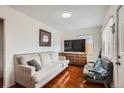 Bright living room showcasing comfortable seating and warm hardwood floors at 6736 Grove St, Denver, CO 80221