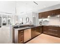 Modern kitchen with sleek cabinetry, stainless steel appliances, and an open layout to the living area at 7600 Landmark Way # 914, Englewood, CO 80111