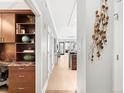 Elegant hallway with built-in shelving and views into the living area and kitchen at 7600 Landmark Way # 914, Englewood, CO 80111