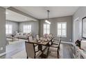 Elegant dining room with a large table, seating for six, and a view into the living room at 2901 Madison Ln, Broomfield, CO 80023