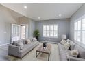 Bright living room with neutral walls, white trim, and two sofas flanking a central window at 2901 Madison Ln, Broomfield, CO 80023
