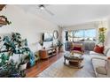 Spacious living room with hardwood floors, sliding glass door to balcony, and plenty of natural light at 1300 Garfield St # 9, Denver, CO 80206