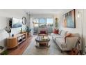 Modern living room with hardwood floors, balcony access, and comfortable seating area at 1300 Garfield St # 9, Denver, CO 80206