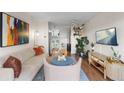Open concept living room with kitchen view, stylish decor, and comfortable seating at 1300 Garfield St # 9, Denver, CO 80206