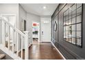Welcoming entryway with hardwood floors, stylish decor, and a view of the staircase at 1669 Stable View Dr, Castle Pines, CO 80108