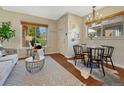 Inviting dining area with a round table and seating for four near a bright window at 732 Poplar St, Denver, CO 80220