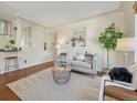 Bright living room featuring hardwood floors, stylish decor, and ample natural light at 732 Poplar St, Denver, CO 80220