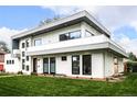 Contemporary home with white brick exterior, gray accents, and a well-maintained lawn at 6435 E 6Th Avenue Pkwy, Denver, CO 80220