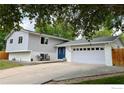 Two story home with a driveway leading up to a two car garage and a blue door at 5389 W Roxbury Pl, Littleton, CO 80128