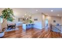 Open-concept kitchen with modern island, stainless appliances, and hardwood floors at 5389 W Roxbury Pl, Littleton, CO 80128