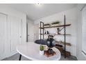 Bright office space with a marble desk, open shelving, and a cozy, functional design for work at 13546 E 103Rd Pl, Commerce City, CO 80022