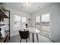 A stylish home office with a modern desk, open shelving, and a view of the outdoors, offering a productive workspace at 13546 E 103Rd Pl, Commerce City, CO 80022