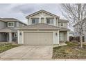 Charming two-story home with a well-maintained lawn and an attached two-car garage at 20785 E 39Th Ave, Denver, CO 80249