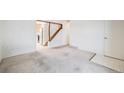 Spacious living room featuring stairs, carpet, and access to the kitchen at 12218 Monroe Dr, Thornton, CO 80241