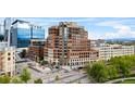 Exterior view of luxurious brick condo building with upscale retail and office space and beautiful landscaping at 1590 Little Raven St # 408, Denver, CO 80202