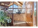 Welcoming entryway featuring stone accents, a staircase, and a glimpse into the living area at 2976 Hiwan Dr, Evergreen, CO 80439