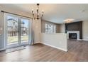 Open dining area featuring wood floors, sliding glass doors, and a decorative chandelier at 1169 N Tabor Dr, Castle Rock, CO 80104