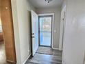 Bright entryway with wood-look floors and door leading to backyard at 7982 Larkspur Cir, Frederick, CO 80530