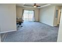 Spacious living room featuring carpeted floors and backyard access at 7982 Larkspur Cir, Frederick, CO 80530