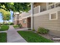 The exterior of the property features well-maintained landscaping and neutral tones, with a sidewalk leading to the entrance at 4385 S Balsam St # 3-101, Littleton, CO 80123