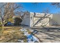 Charming home featuring an attached two-car garage, driveway, and landscaping with snow at 246 S 22Nd Ave, Brighton, CO 80601