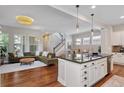 Open-concept kitchen and living room with modern lighting and a large sectional at 817 Uinta Way, Denver, CO 80230