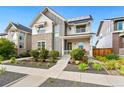 Stylish two-story home with stone accents, front yard landscaping, and a welcoming porch at 10295 E 59Th Ave, Denver, CO 80238