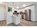 Modern kitchen boasts white cabinets, stainless steel appliances, and a breakfast bar perfect for casual dining at 715 S Alton Way # 5A, Denver, CO 80247
