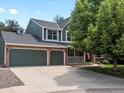 Charming two-story home features a three-car garage and a welcoming front porch at 8953 W Brandt Pl, Littleton, CO 80123
