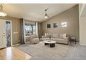 Bright living room with vaulted ceiling, neutral color palette, and comfy seating at 3008 Mountain Sky Dr, Castle Rock, CO 80104