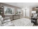 Inviting living room featuring wood floors, multiple windows with natural light and neutral paint at 6514 Zinnia St, Arvada, CO 80004