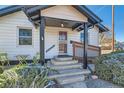 Inviting front porch with wood railing, steps and cute landscaping at 101 S 11 Ave, Brighton, CO 80601