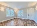 Bright living room with hardwood floors, large windows and modern lighting at 101 S 11 Ave, Brighton, CO 80601