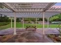 Inviting outdoor patio with a pergola, stone pavers, and a picnic table at 5735 Big Canon Dr, Greenwood Village, CO 80111