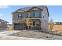 Two-story house with stone and siding accents, a two-car garage, and landscaping at 4607 Cattle Cross Trl, Castle Rock, CO 80104