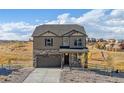 Two-story house with stone and siding accents, a two-car garage, and landscaping at 4607 Cattle Cross Trl, Castle Rock, CO 80104