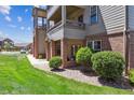 Charming condo exterior with a private covered patio and lush green lawn at 12914 Ironstone Way # 102, Parker, CO 80134
