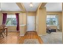 Bright foyer with hardwood floors, leading to carpeted living areas and multiple windows at 16823 Weber Way, Mead, CO 80542